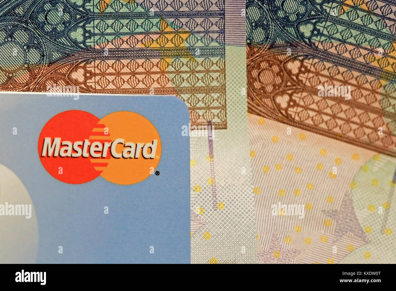 SALO, FINLAND - OCTOBER 19, 2014: MasterCard credit card sign close up over Euro cash. MasterCard Brings Contactless Payment to the 2014 World Series. Stock Photo