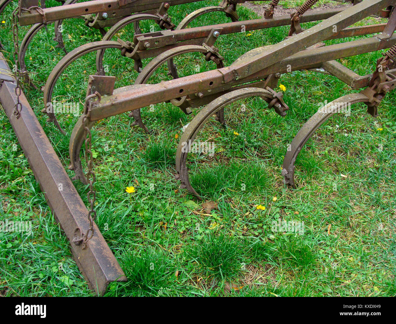 Old tractor powered cultivator on grass close up Stock Photo Alamy