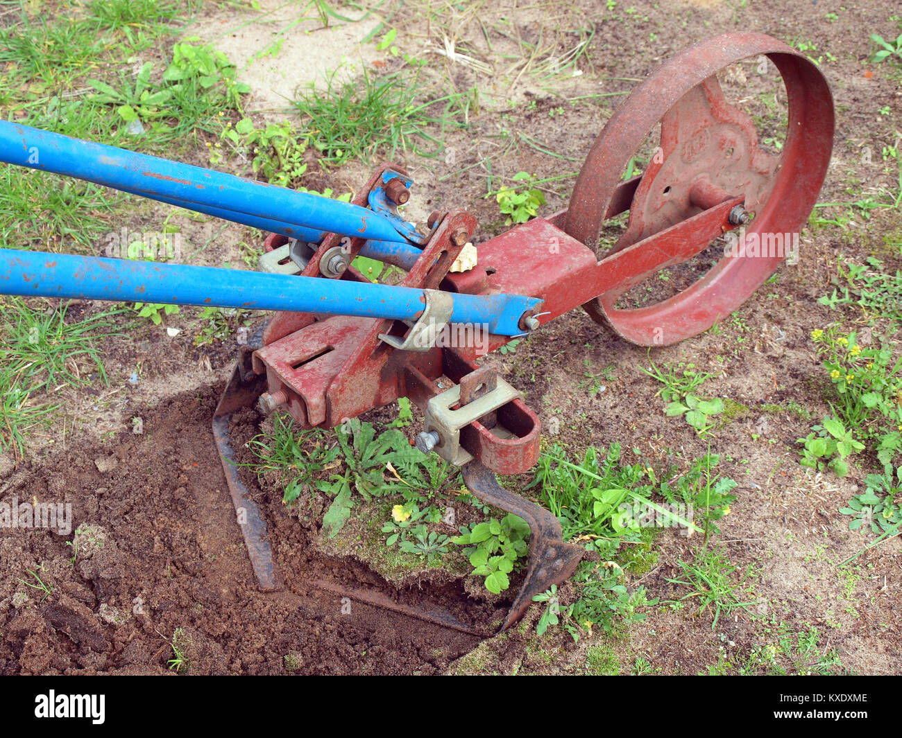 Tilling the soil with pushed by hands garden cultivator Stock Photo Alamy