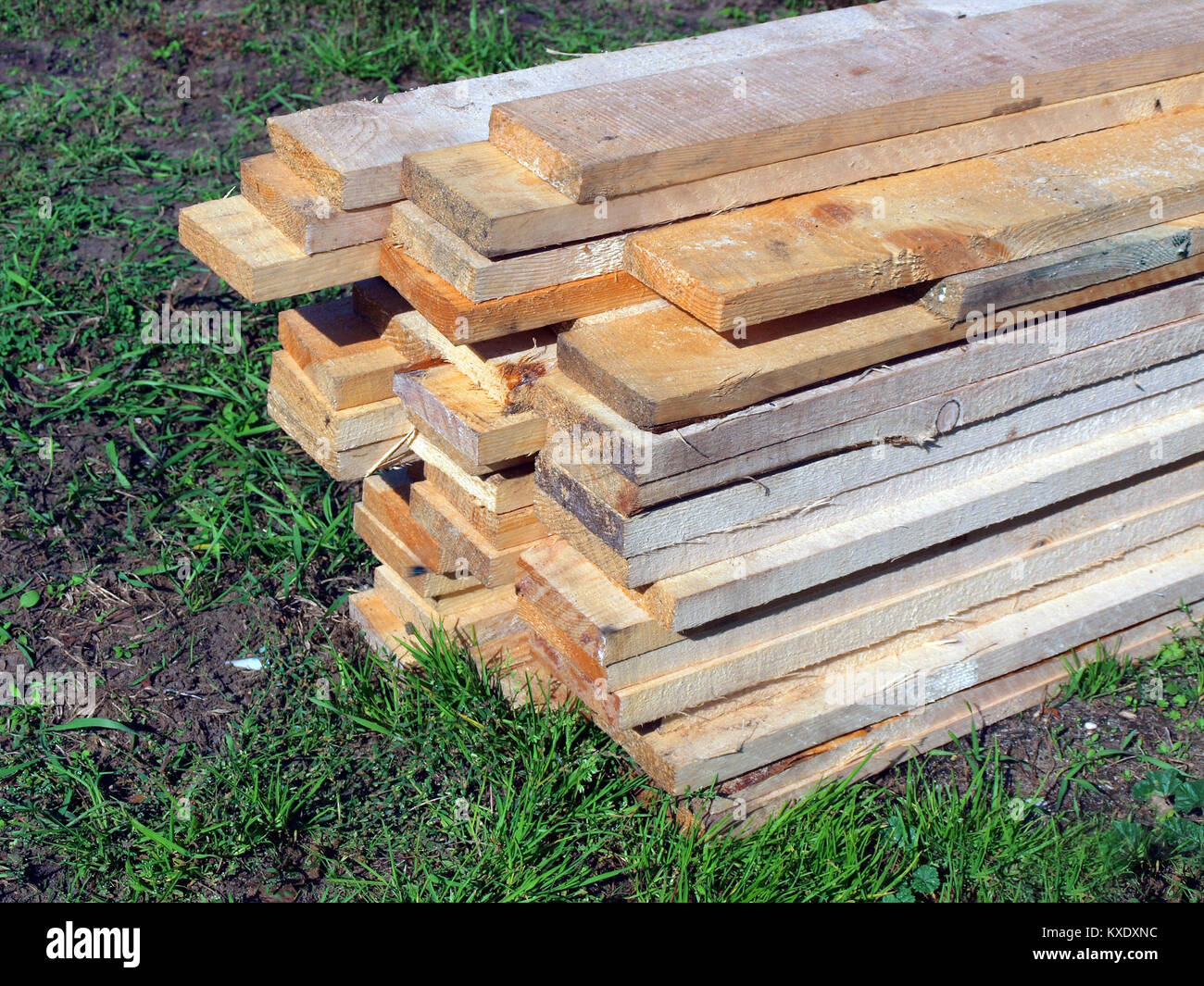 Stack of raw wooden boards on grass close up Stock Photo Alamy