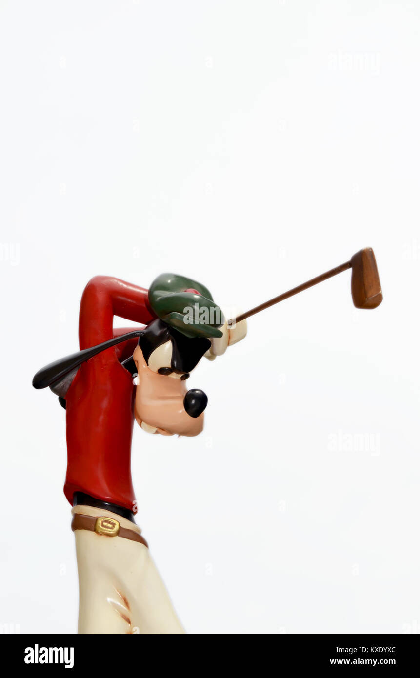 Monchique, Faro - Portugal, Circa, March 2013. Studio image of Goofy figure swinging a golf club with a white isolated background.  Goofy was produced Stock Photo