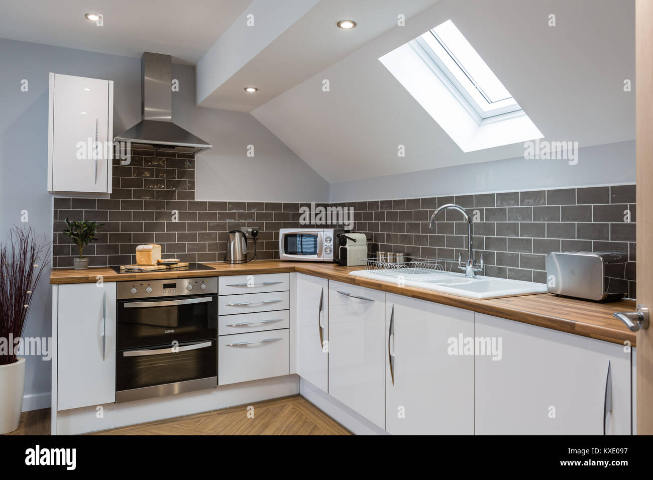 Modern white kitchen units with wooden work tops Stock Photo - Alamy