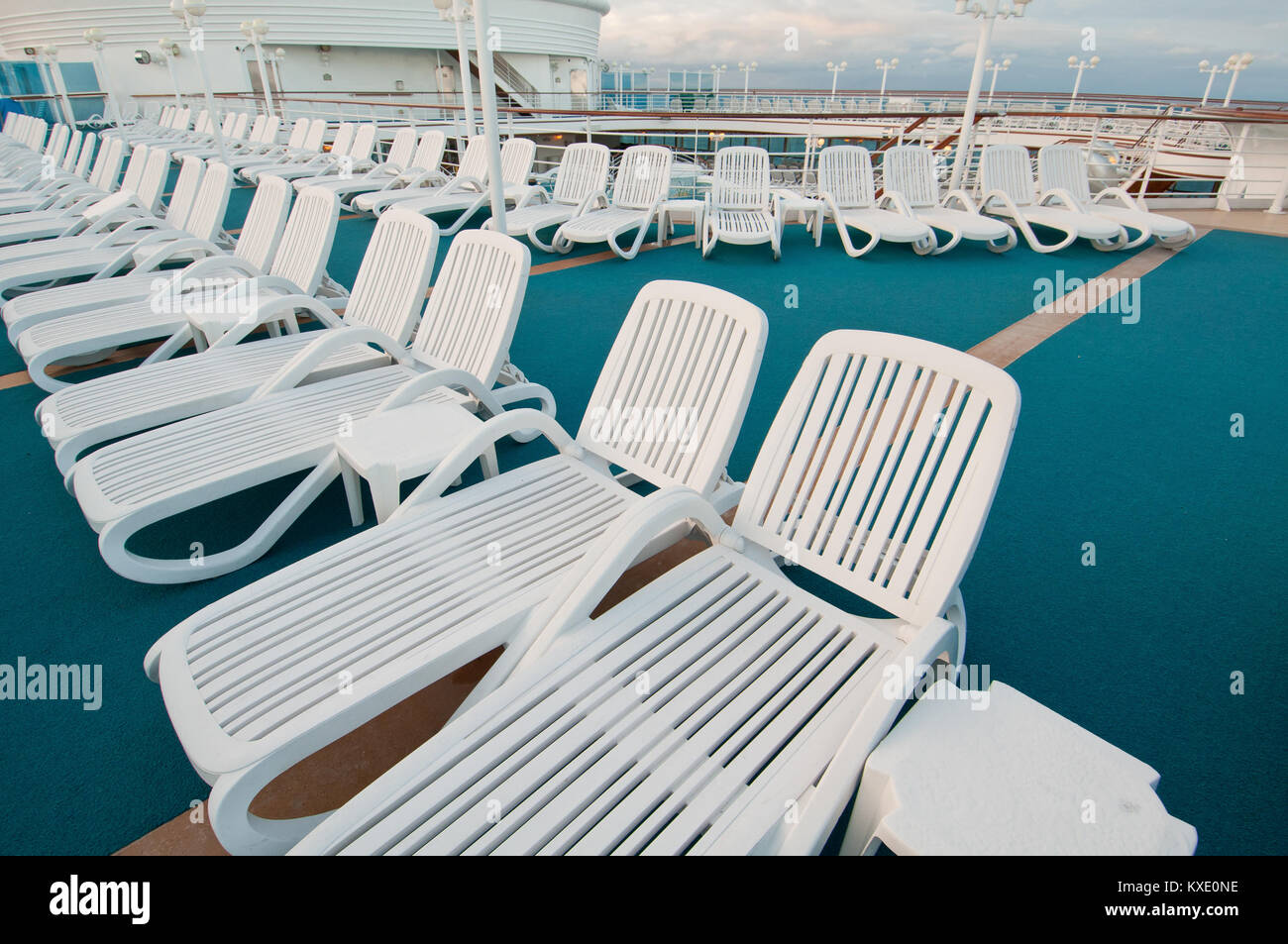 Many sun tanning beach chairs on top deck of cruise ship Stock