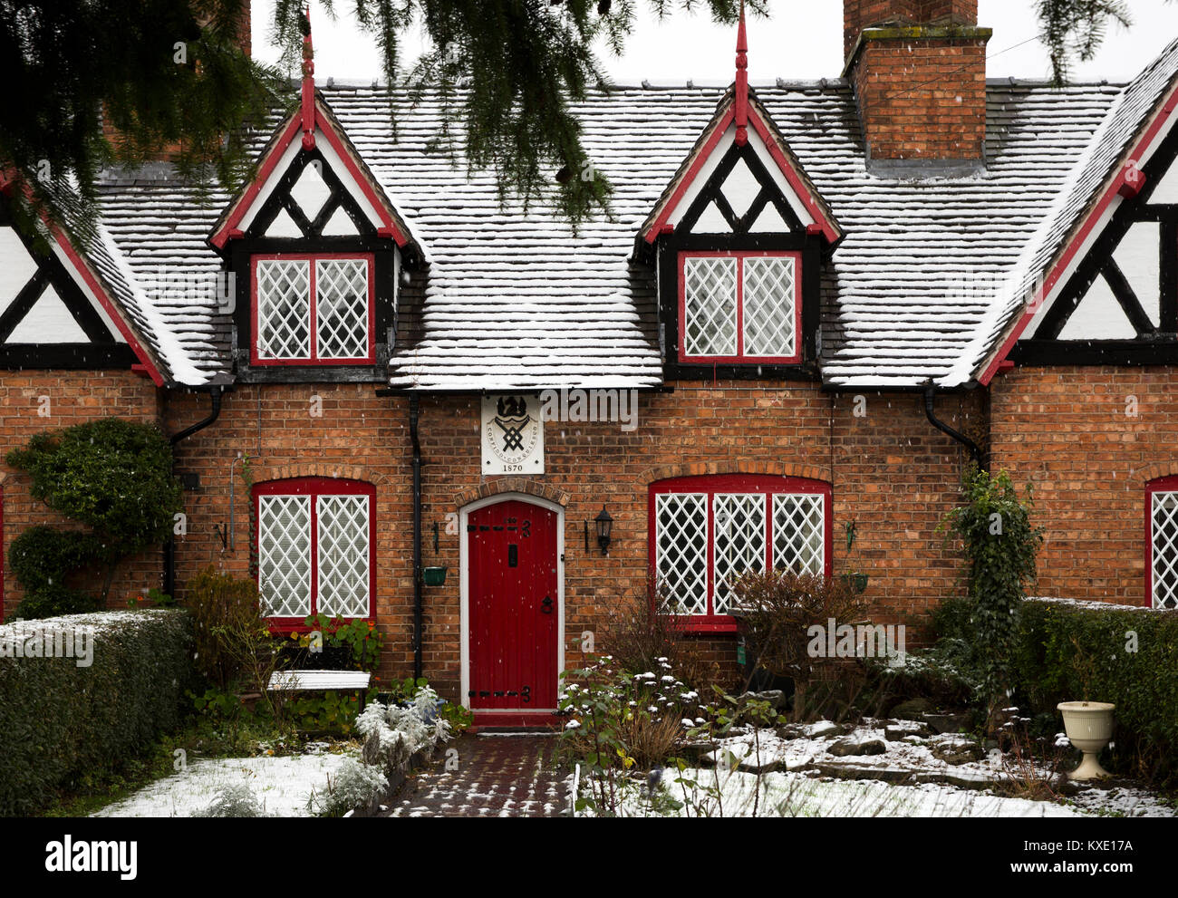 UK, England, Cheshire, Nantwich, Welsh Row, Sir Roger Wilbraham’s (Tollemache’s) Almshouses, garden and front door in snow Stock Photo