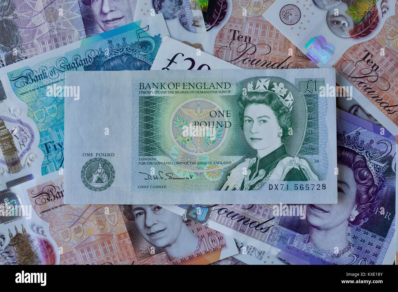 British £1 pound banknote with the new polymer banknotes in the background Stock Photo