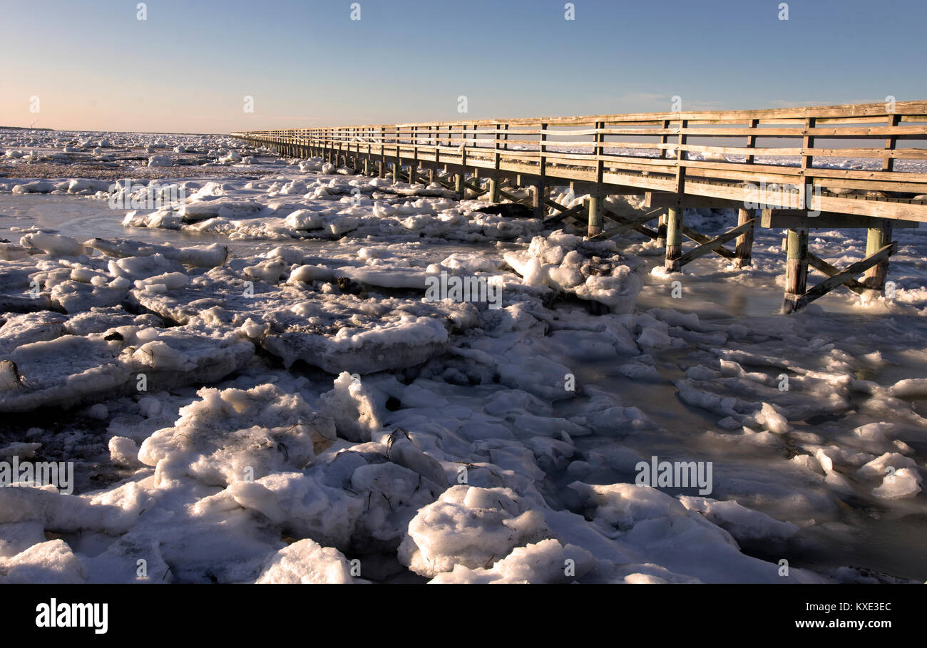 The boardwalk and ice at Bass Hole in Yarmouth Port, Massachusetts on