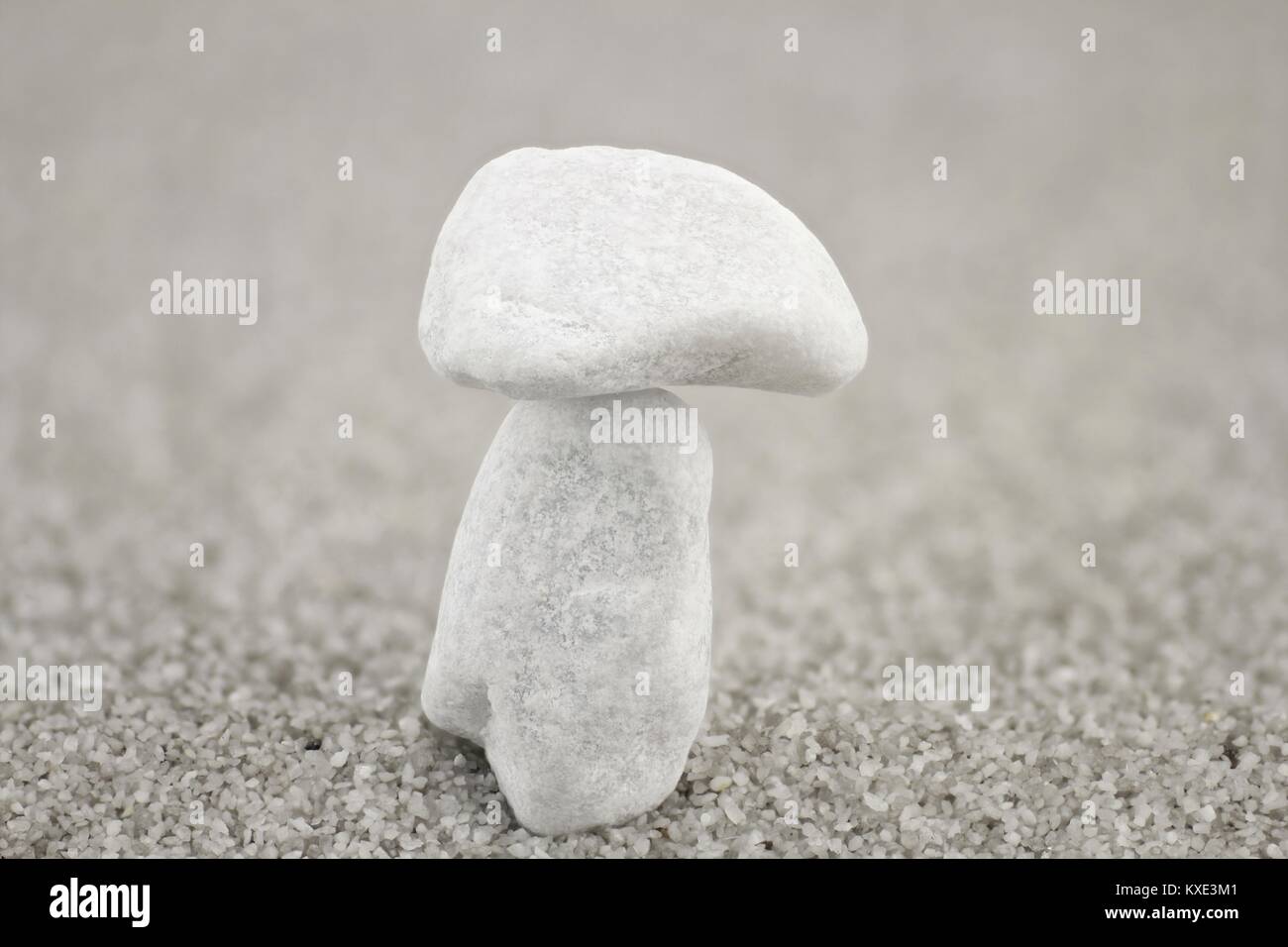 White pebbles on top of each other in the form of a mushroom Stock Photo