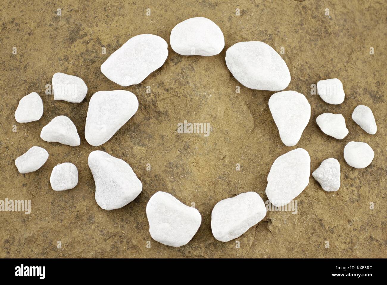 Pattern with circle of pebbles on brown stone Stock Photo