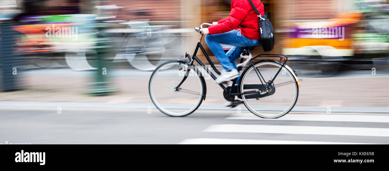 picture of an unrecognizable bicycle rider riding a bike on a road in ...