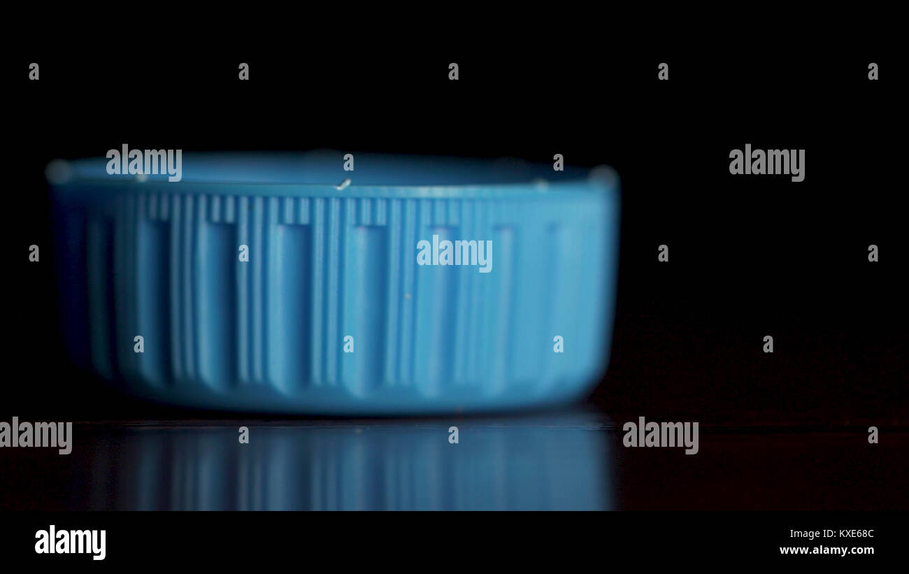 Blue plastic bottle cap isolated on black background. Bottle top