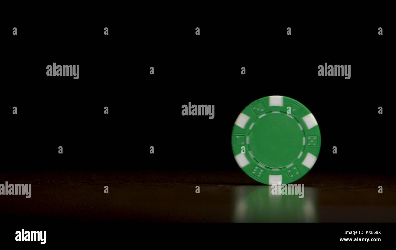 Rotation of poker chips on the table isolated on black background. Poker chips shaffling. Poker