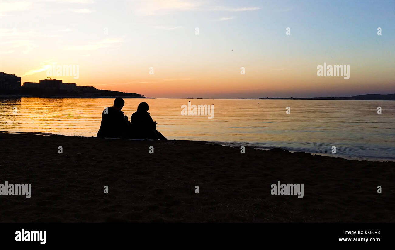 Silhouette of man and woman watching the sunset. Silhouette of the ...