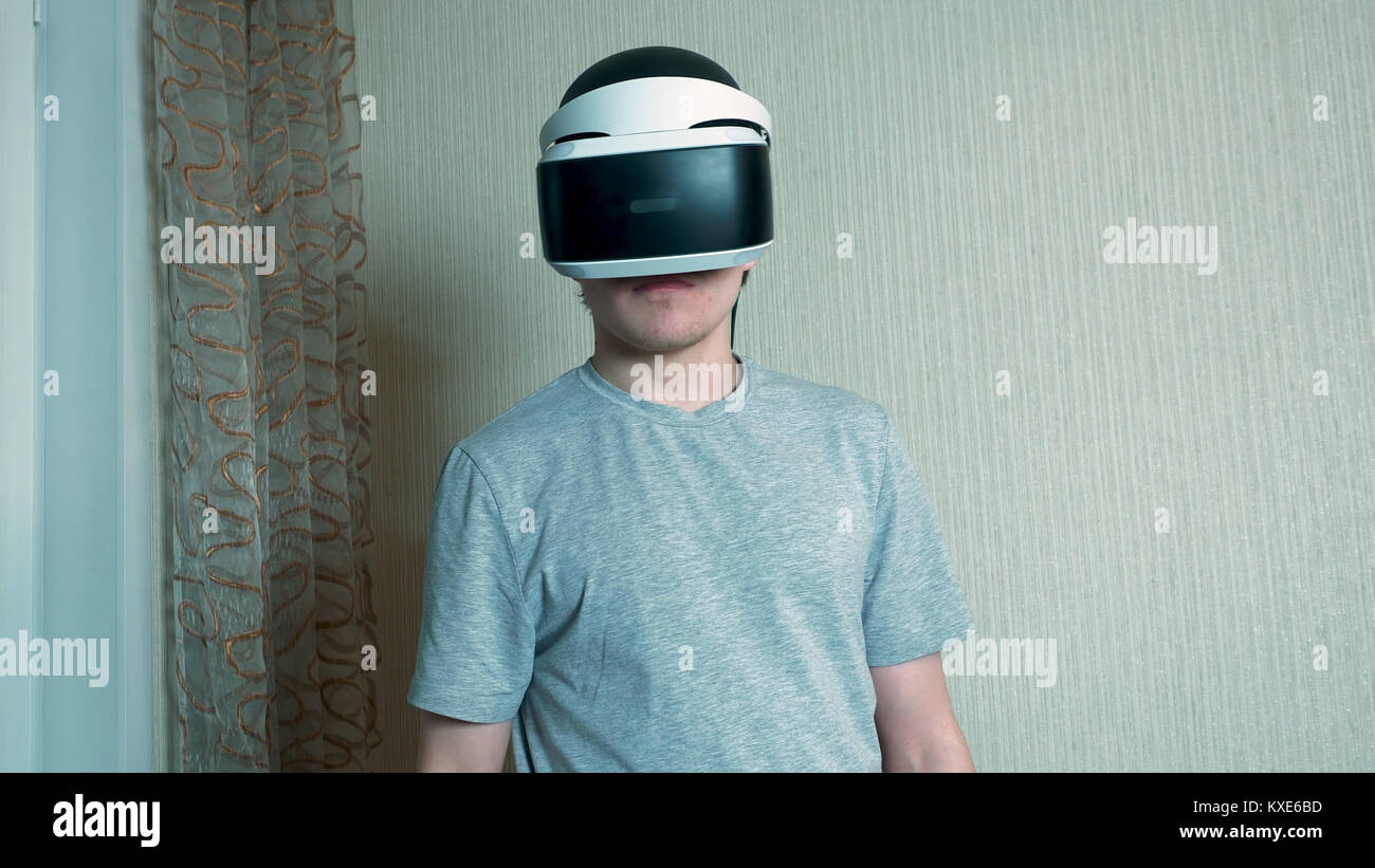 Man In Studio Wearing Virtual Reality Headset Playing Game. Attractive man wearing virtual