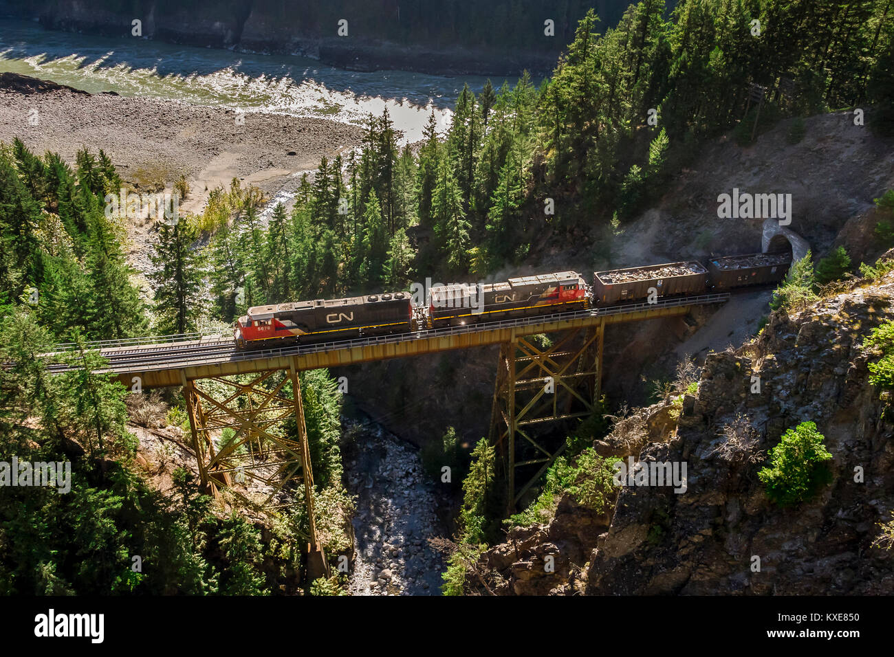 CNR manifest freight westbound exits Ainslee tunnel onto Ainslee bridge near Boston Bar in