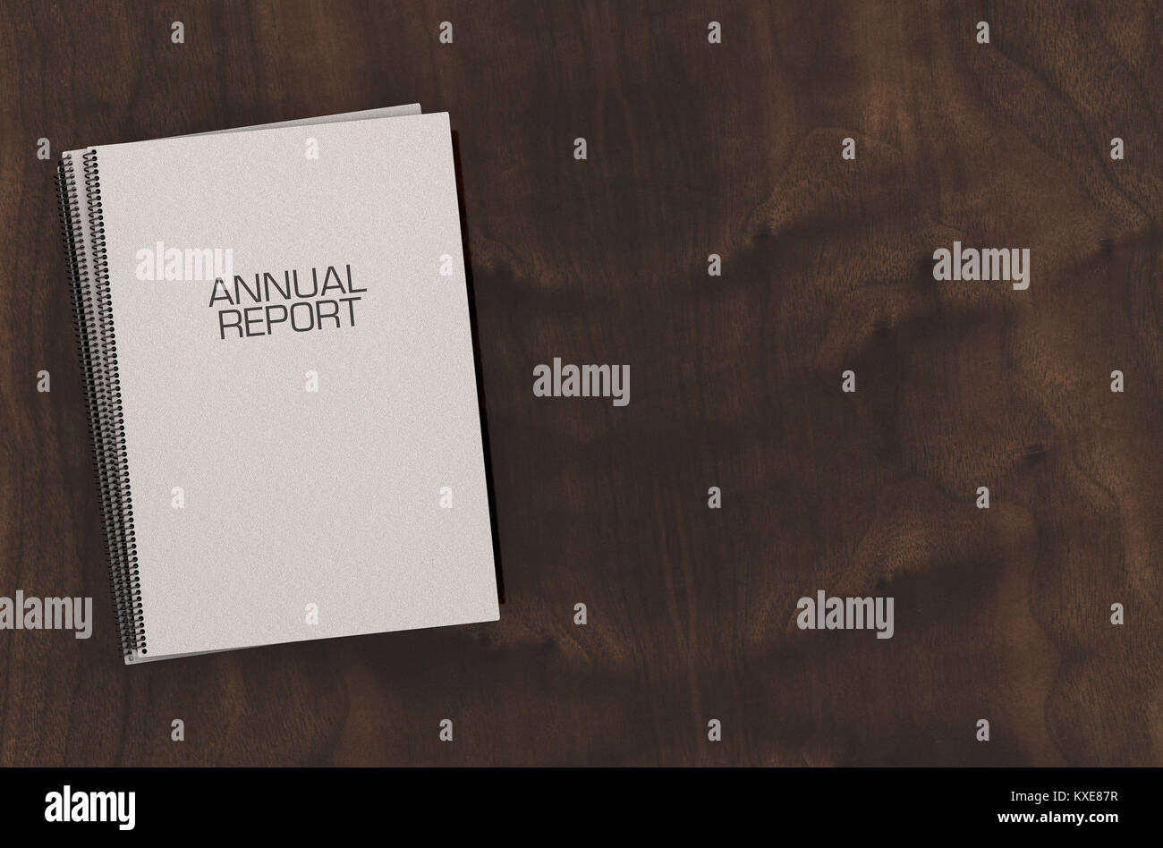 A pile of wire bound annual report documents in a pile on a boardroom ...