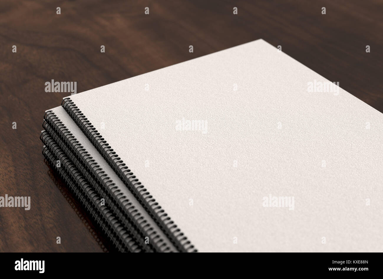A pile of blank wire bound book documents in a pile on a boardroom table surface - 3D render Stock Photo
