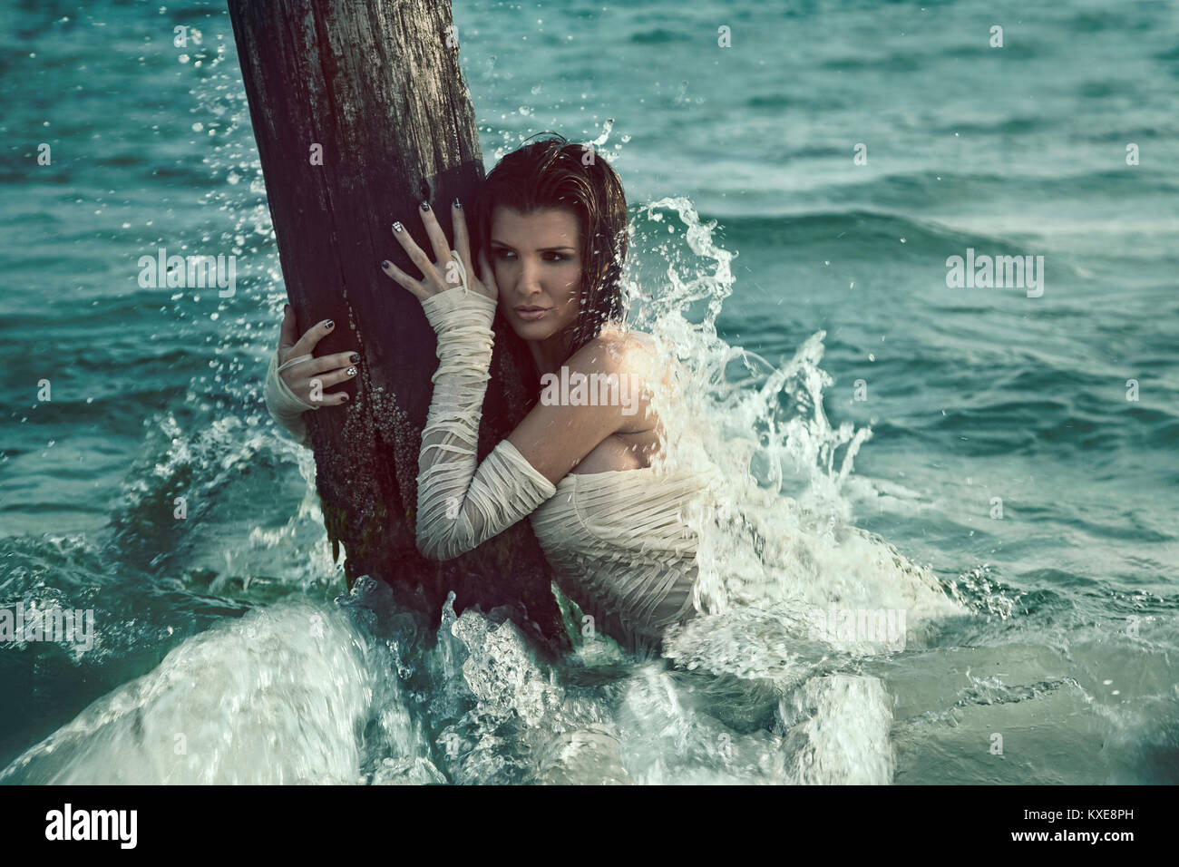 Beautiful woman in white dress on the beach Stock Photo - Alamy