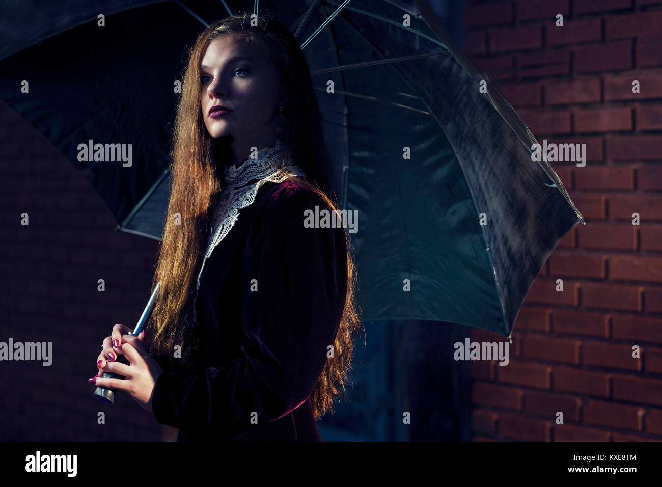 woman with victorian dress and umbrella Stock Photo
