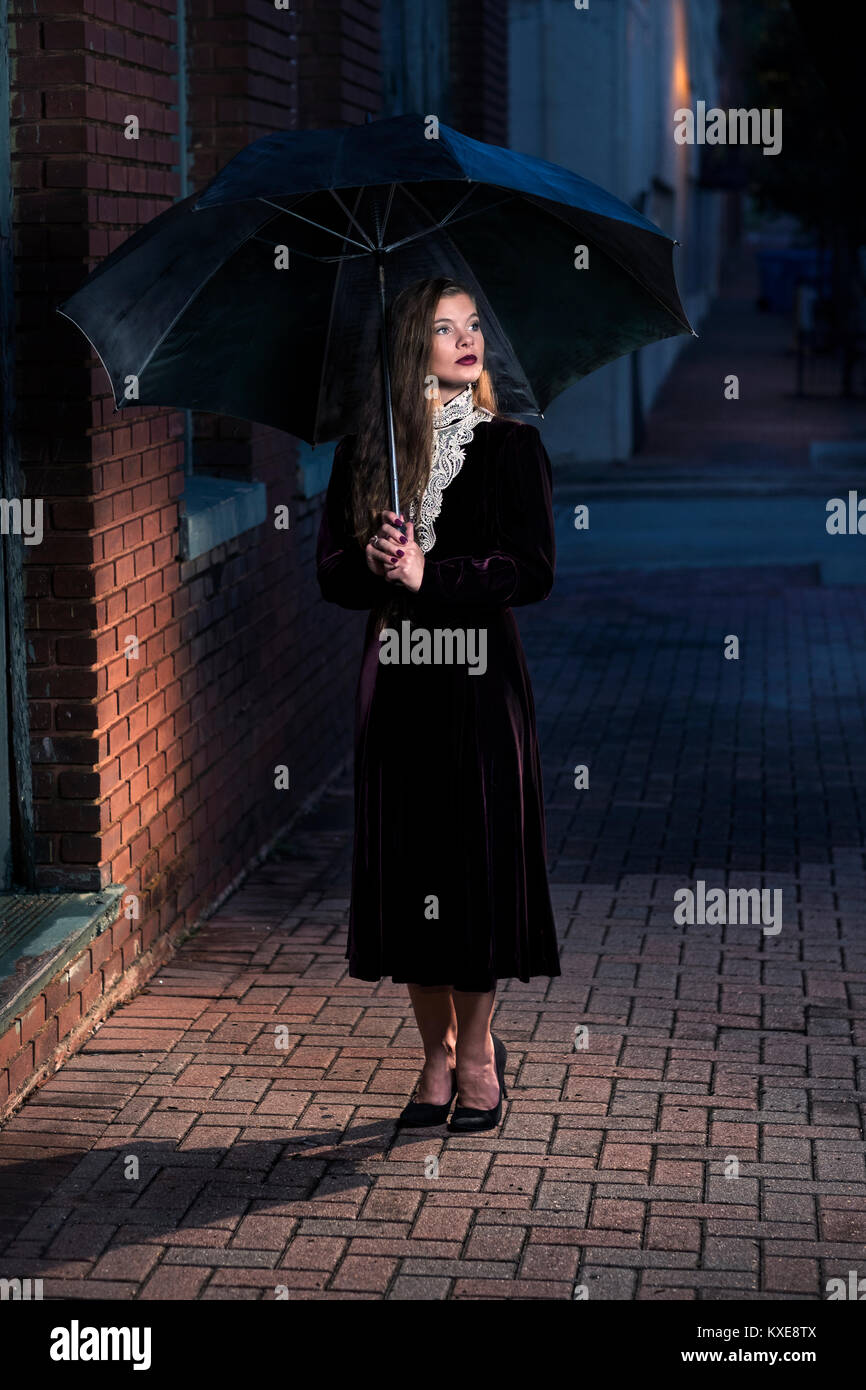 woman with victorian dress and umbrella Stock Photo