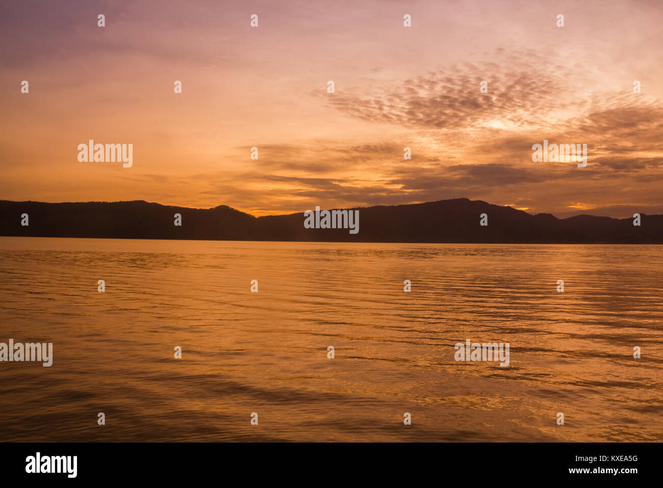 Sunset Sunrise with reflections at Lake Toba, Samosir Island, Indonesia. Stock Photo