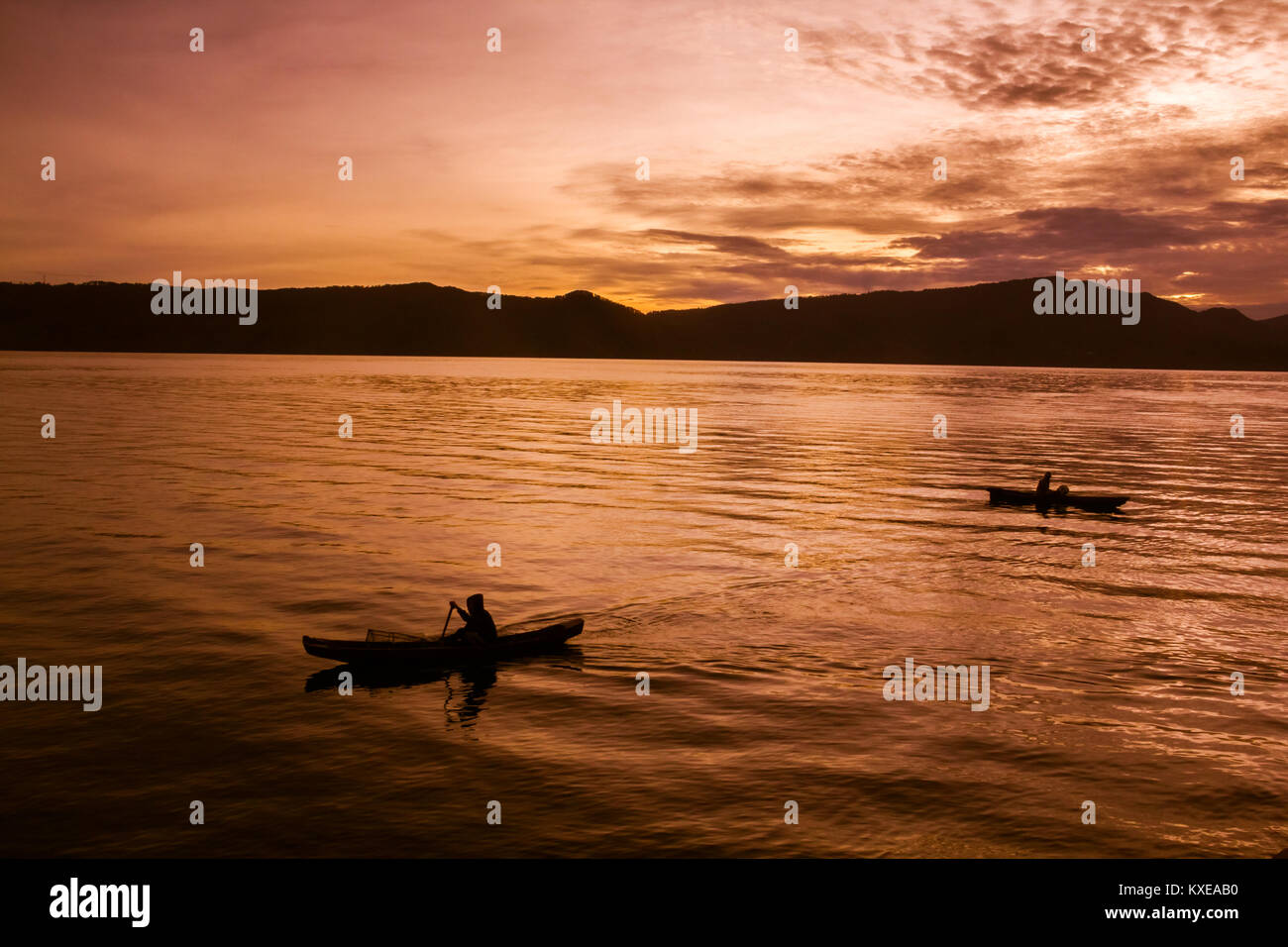 Sunset Sunrise with reflections at Lake Toba, Samosir Island, Indonesia. Stock Photo