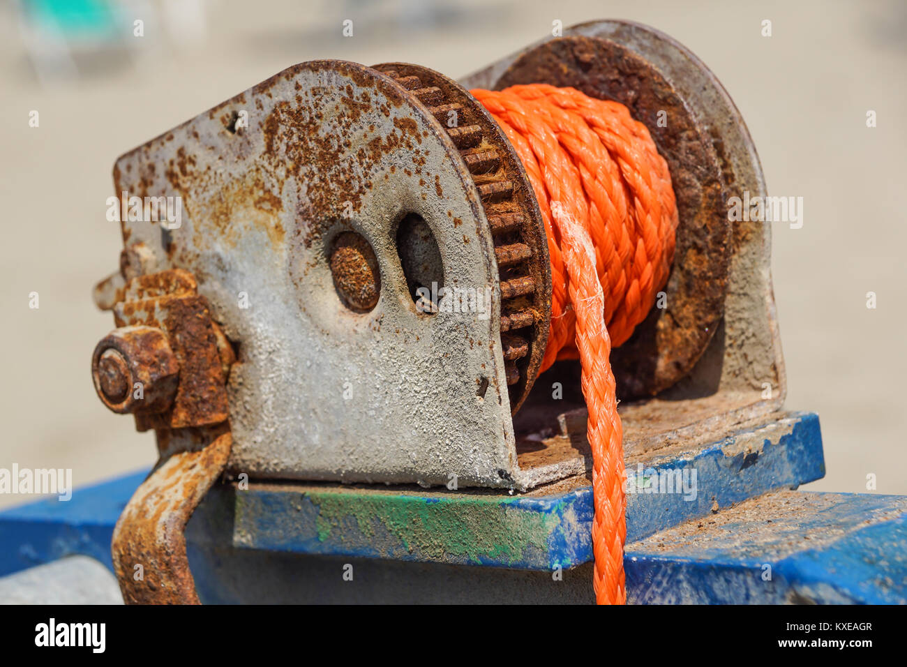 rope wrapped around a well winder An old manila rope wrapped neatly and tightly around a pole. Stock Photo
