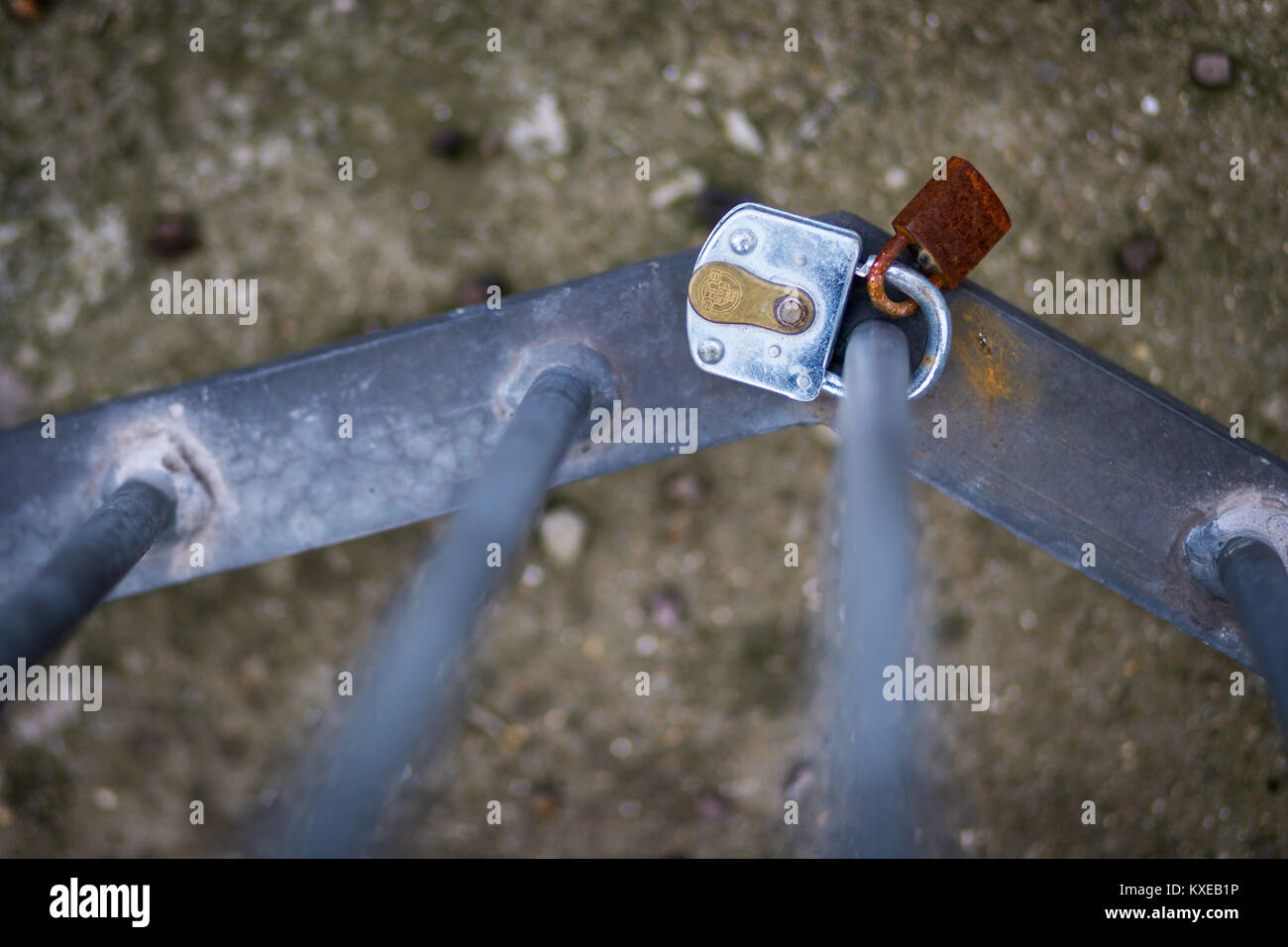 Small padlocks on a railing along the side of the River Thames. A modern token of displaying love Stock Photo
