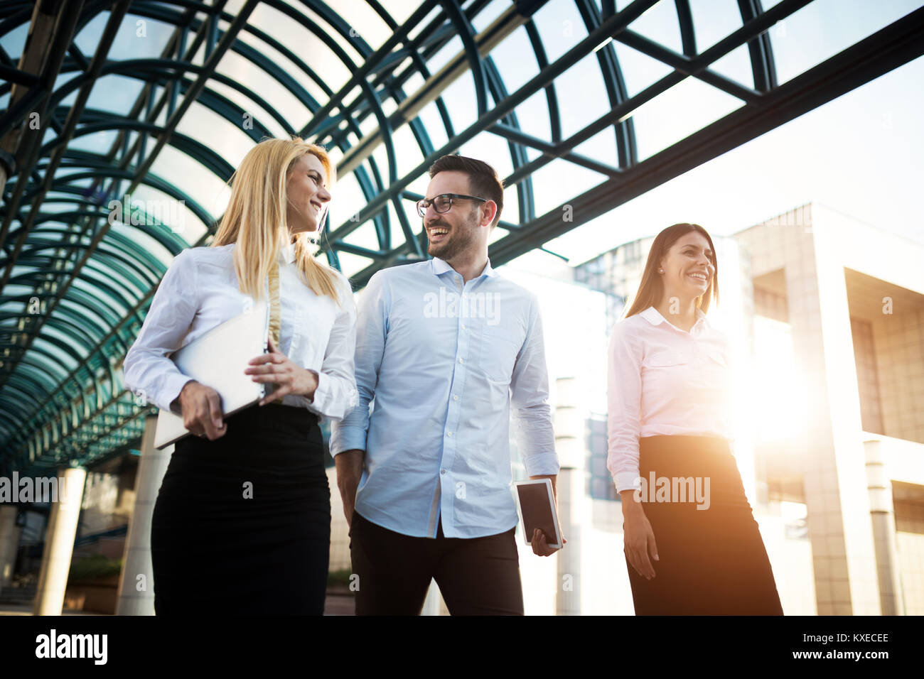 Picture of young attractive business partners standing Stock Photo - Alamy