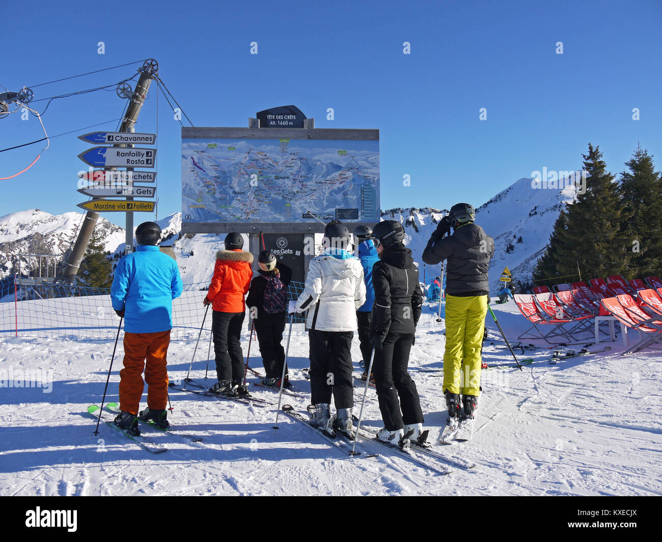 Top of Chavannes ski lifts, skiers llooking at the piste map on the board Stock Photo