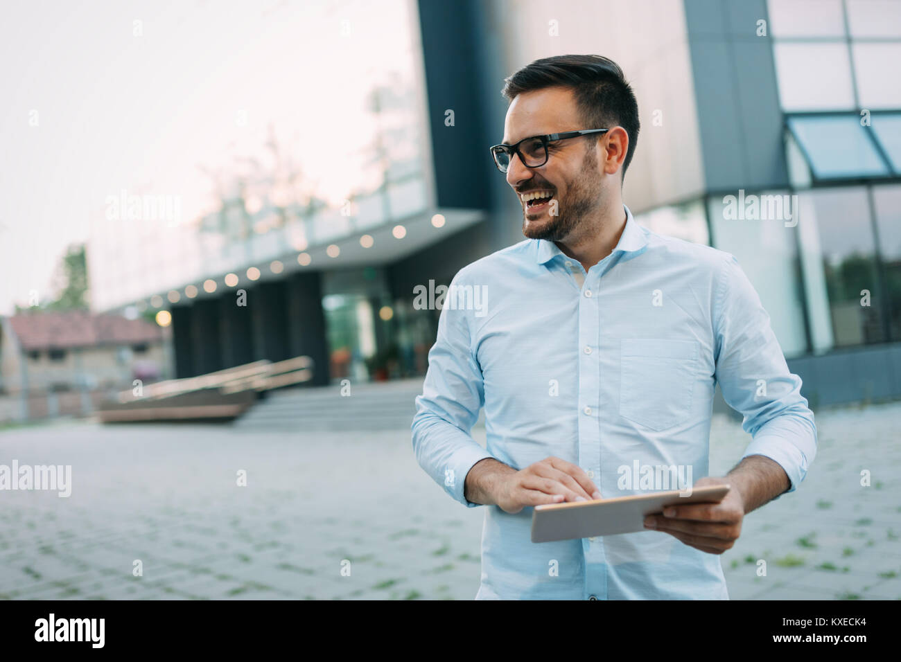 Portrait of handsome young businessman on street Stock Photo - Alamy