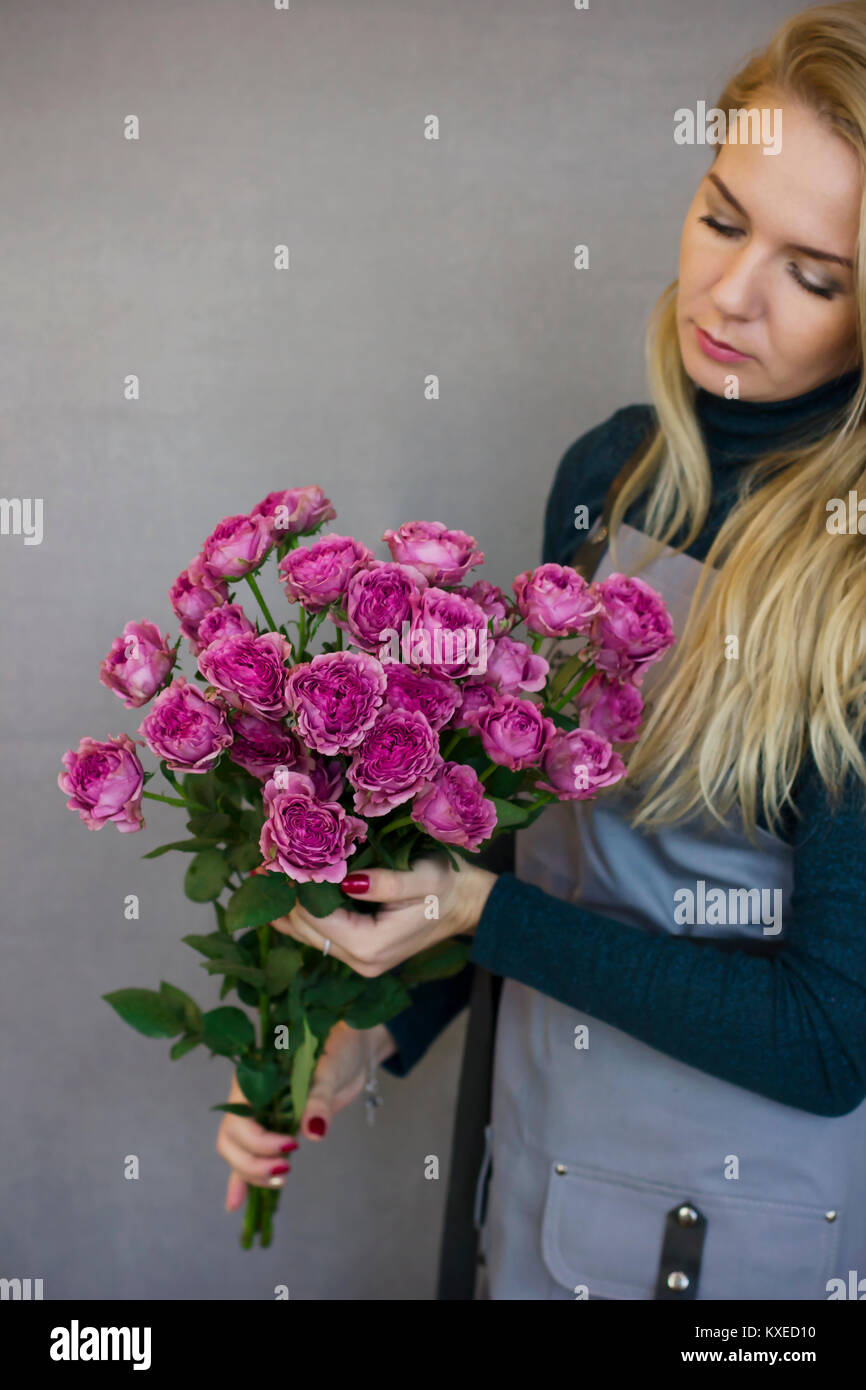 Beautiful young woman holding big bouquet of pink roses Stock Photo - Alamy