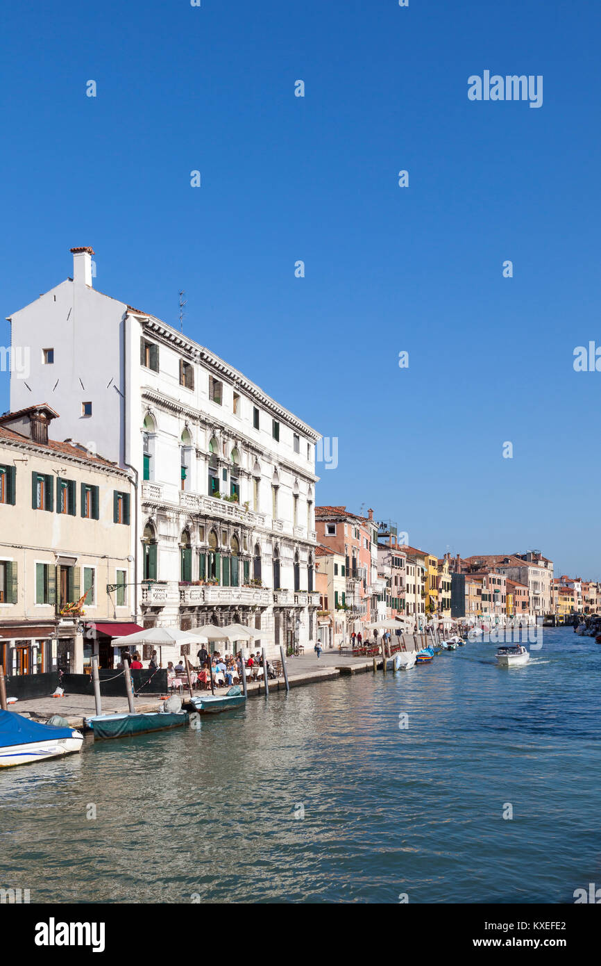 Cannaregio Canal, Cannaregio, Venice, Italy in summer sunshine with tourists dining outdoors alongside the canal Stock Photo