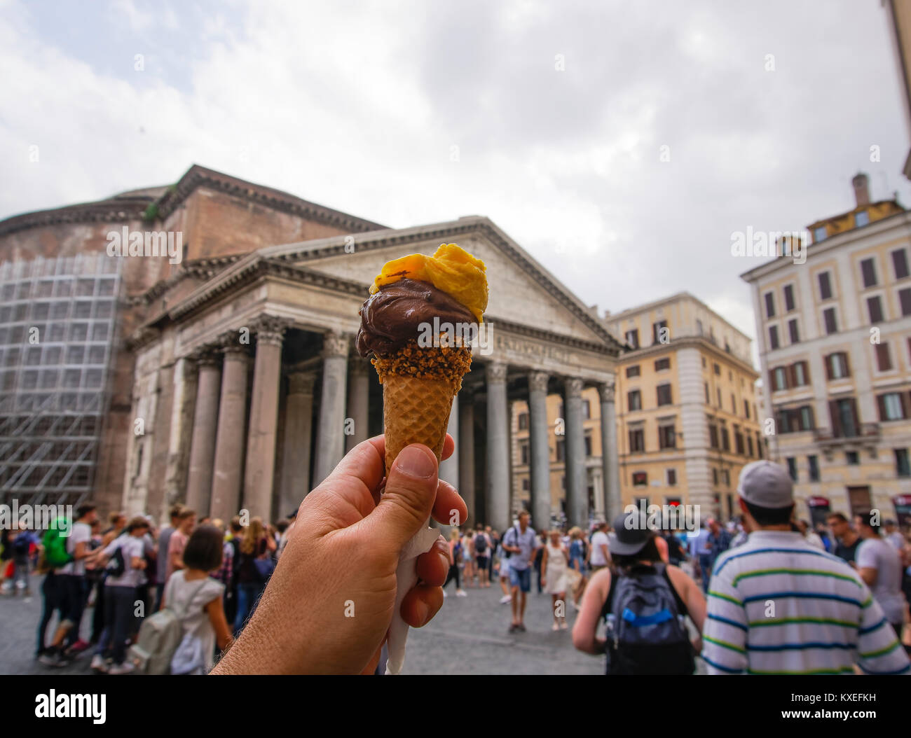 Hand holding ice cream in Rome. Ice cream cone with chocolate and mango flavor before blurred background of Pantheon landmark in Piazza della Rotonda Stock Photo Alamy