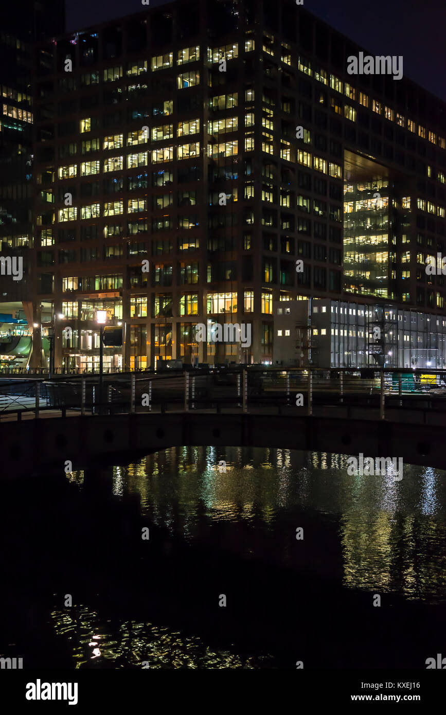Office building with lighted windows in Canary Wharf financial district ...