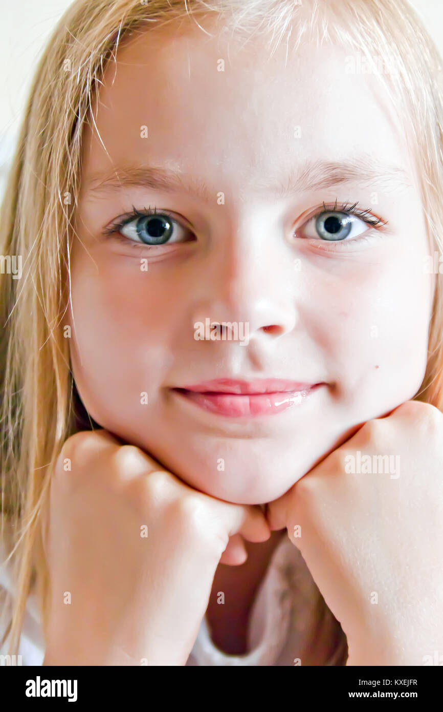 Cute girl with blond long hair and blue eyes Stock Photo - Alamy