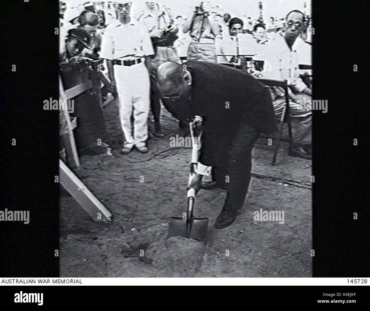 Mr. Ito, Vice President of the Hiroshima Peace Society, plants a camphor tree symbolizing peace, renewal, and remembrance. The event promotes Hiroshima’s commitment to global peace and recovery. Stock Photo