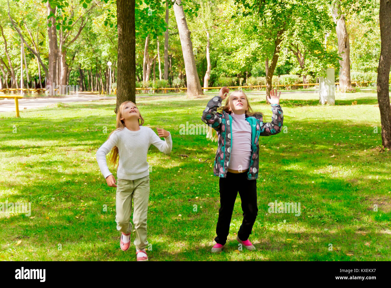 Two girls jumping hi-res stock photography and images - Alamy