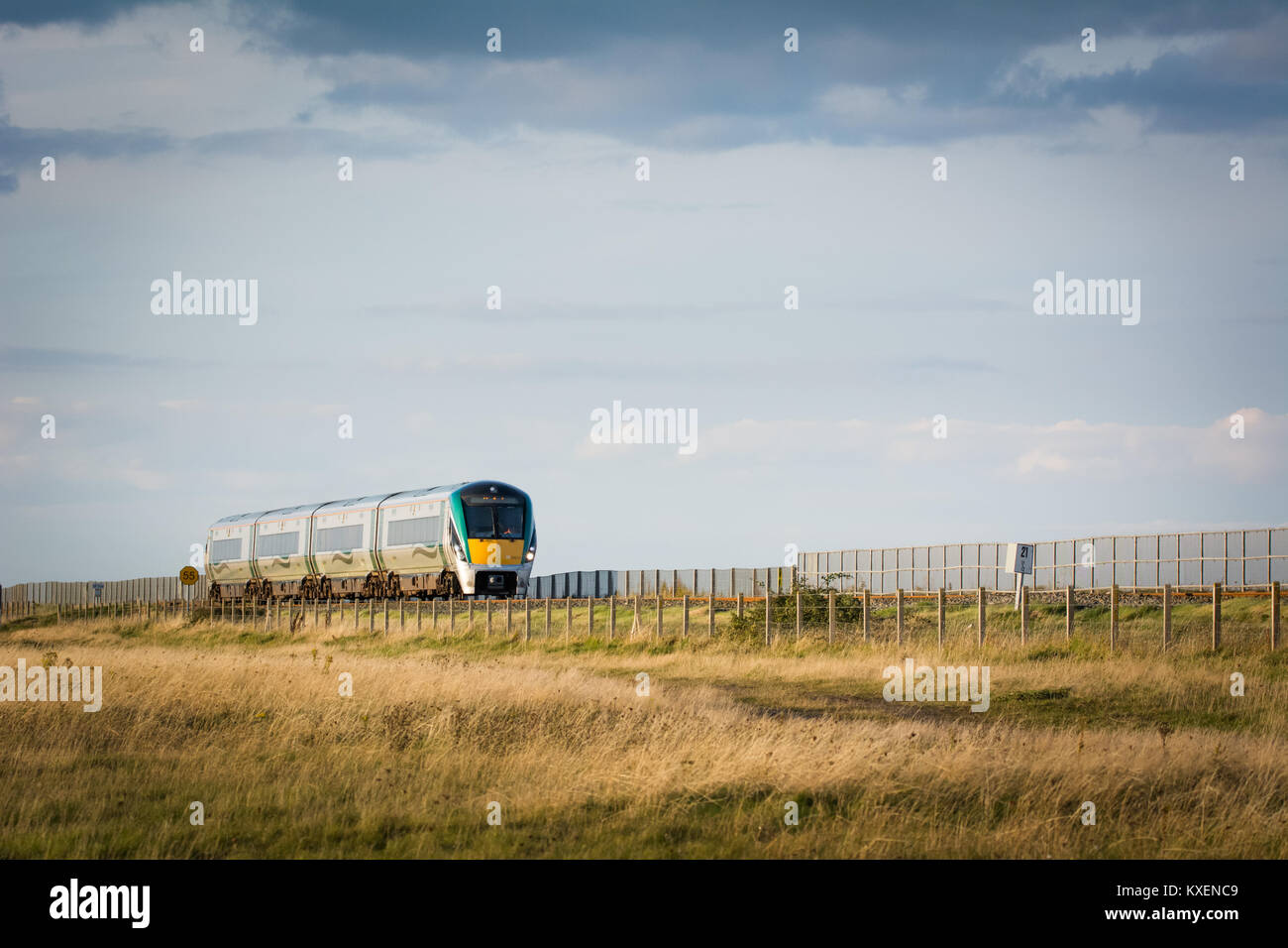 Irish Rail train traveling through Wicklow near Kilcoole along the east coast line in Ireland. Stock Photo