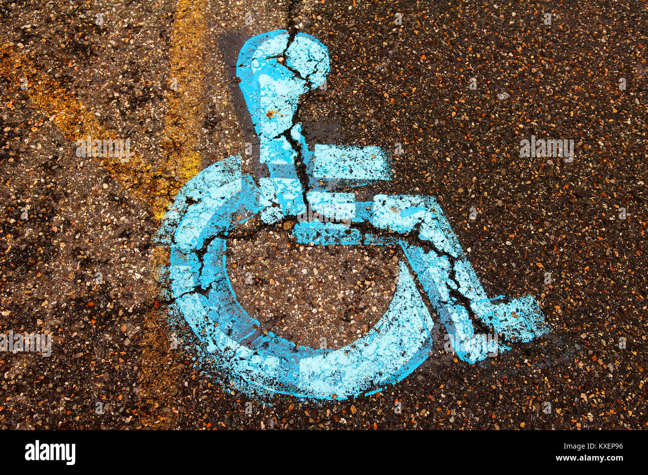 Handicapped sign on torn tar on disabled parking lot,USA Stock Photo