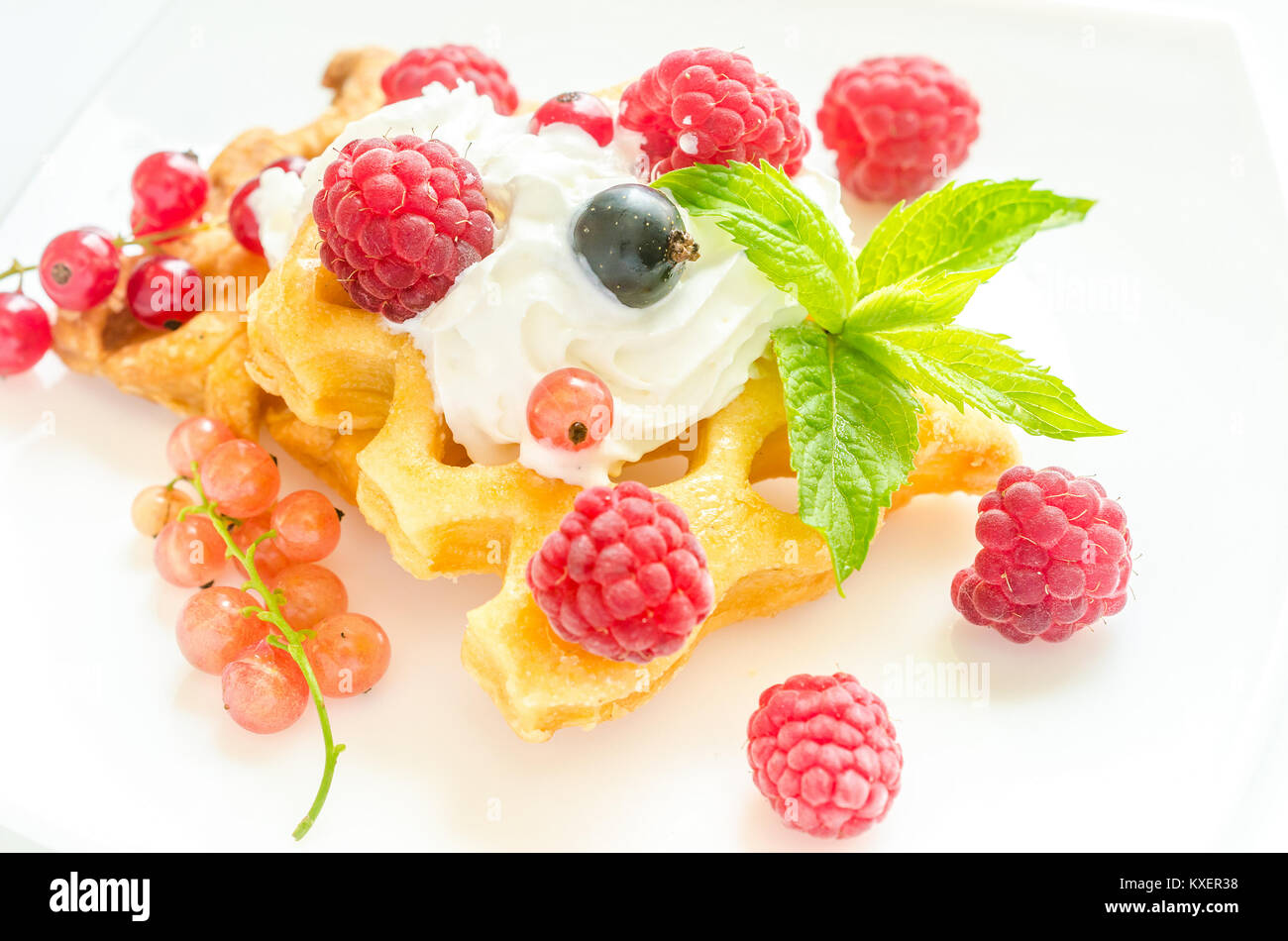 Belgian waffles with whipped cream and fresh berries Stock Photo - Alamy