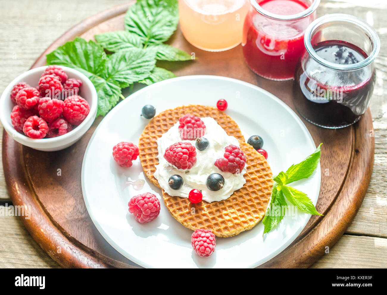 Belgian waffles with whipped cream and fresh berries Stock Photo - Alamy