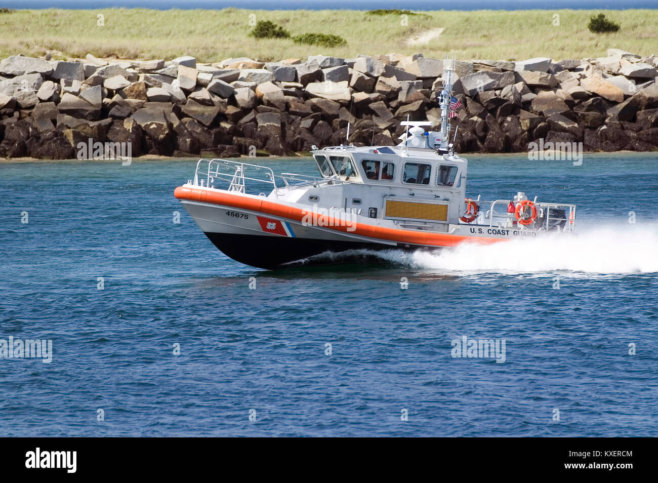 A US Coast Guard boat underway in the Cape Cod Canal in Sandwich, Massachusetts Stock Photo