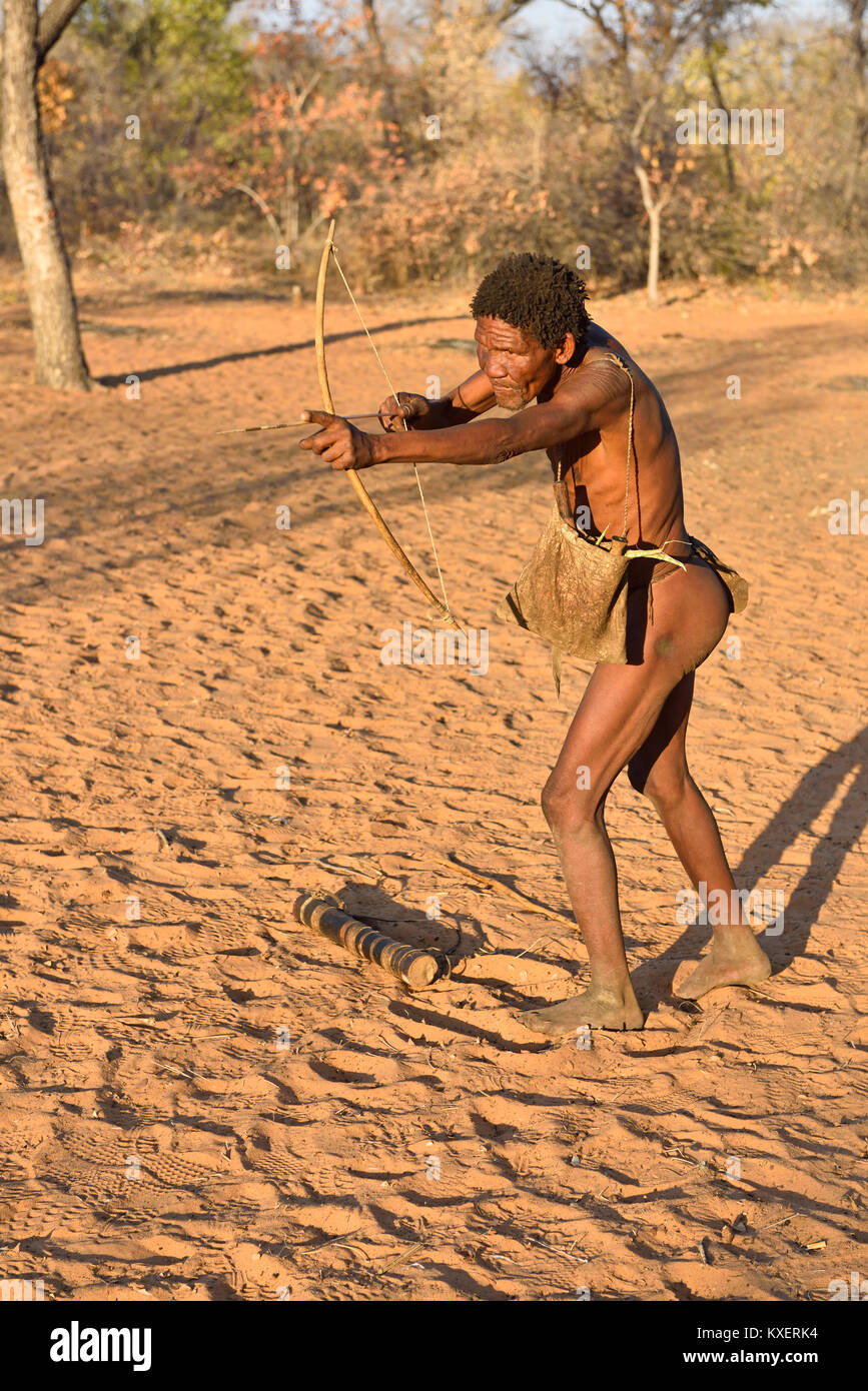 man hunting fish with bow and arrow attached to string Stock Photo - Alamy