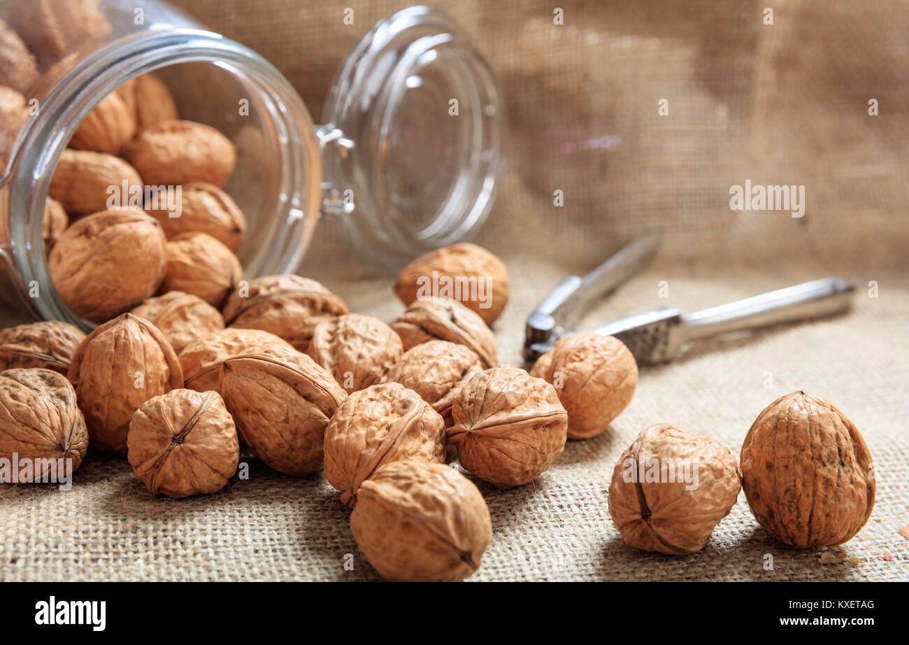 Walnuts and a nutcracker on a table Stock Photo