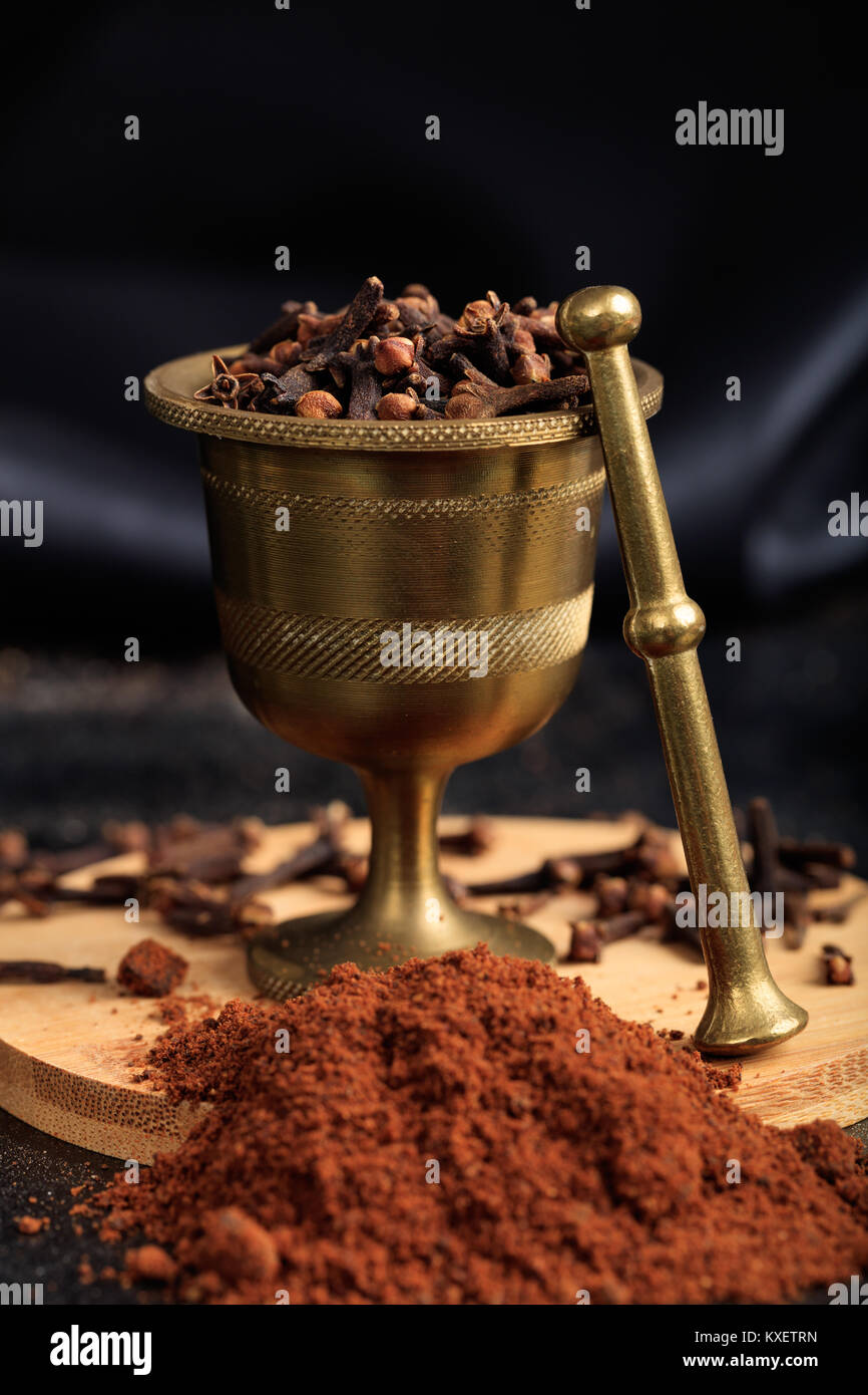 Clove spice seeds and powder on a black background Stock Photo Alamy
