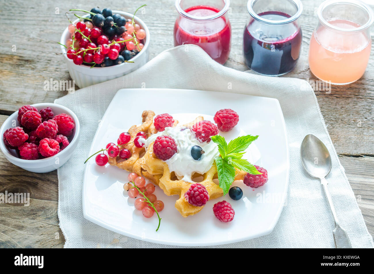 Belgian waffles with whipped cream and fresh berries Stock Photo - Alamy