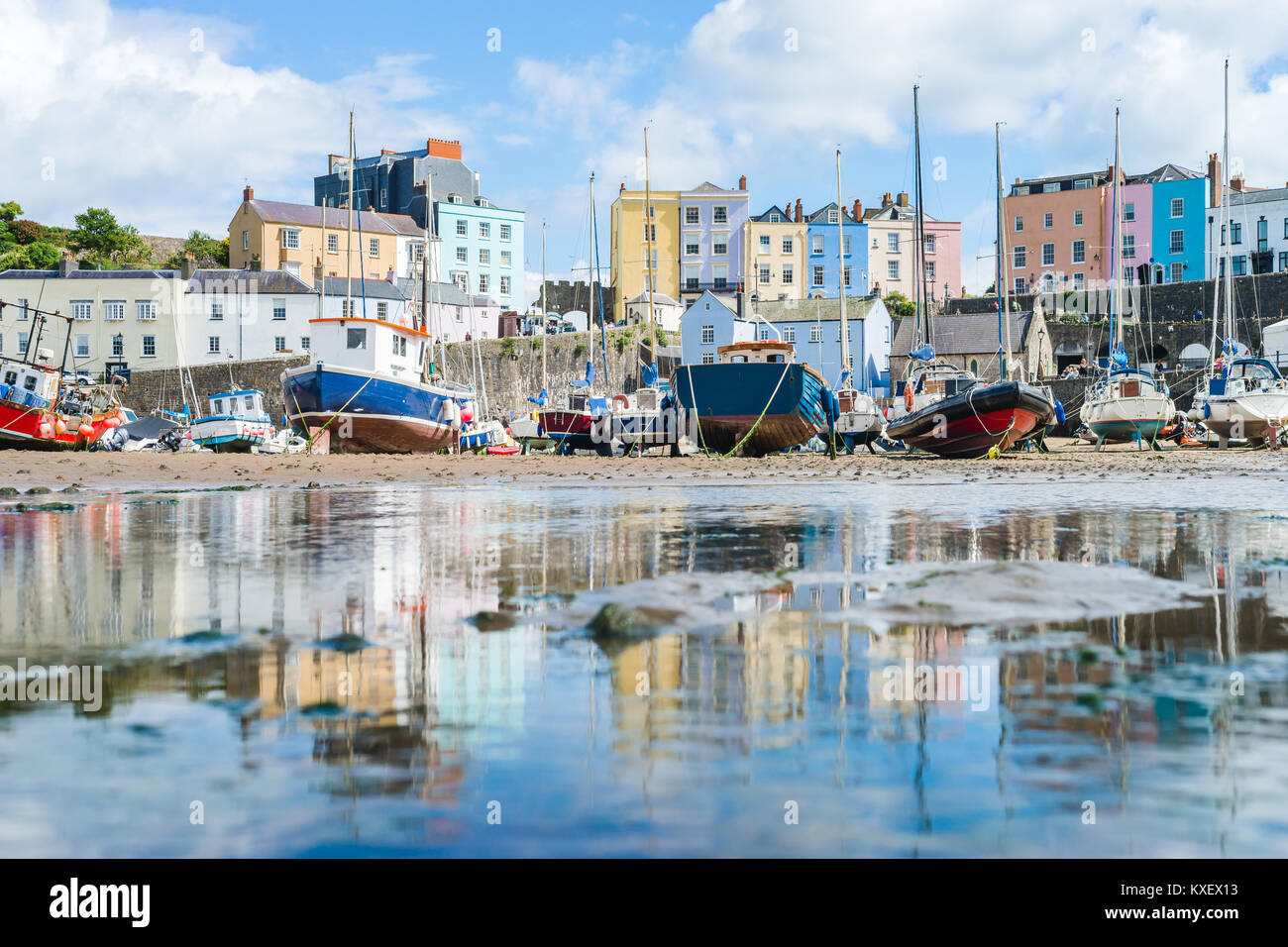 Boats in the bay at low tide with town view in Tenby bay, Wales Stock Photo