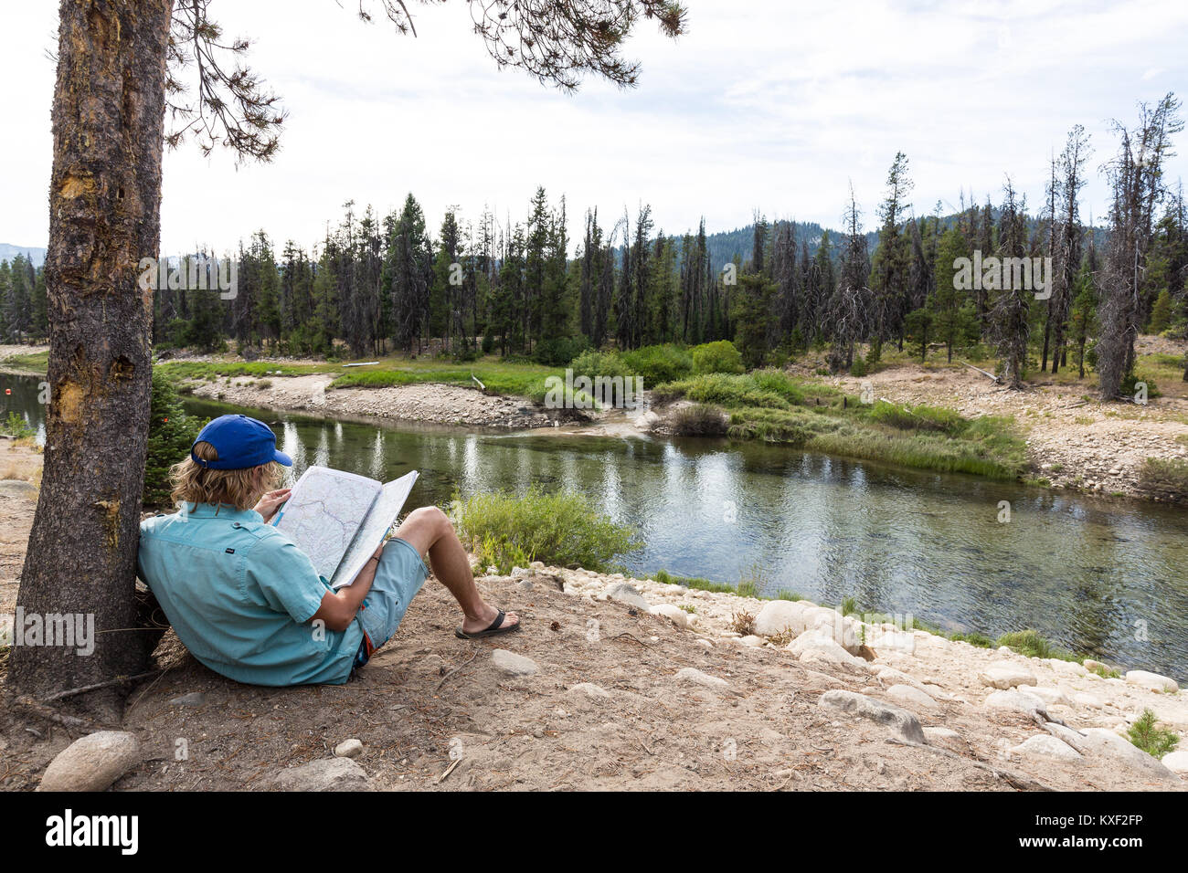 A man studies a roadmap while enjoying a view of Deadwood Reservoir in Boise National Forest. Stock Photo