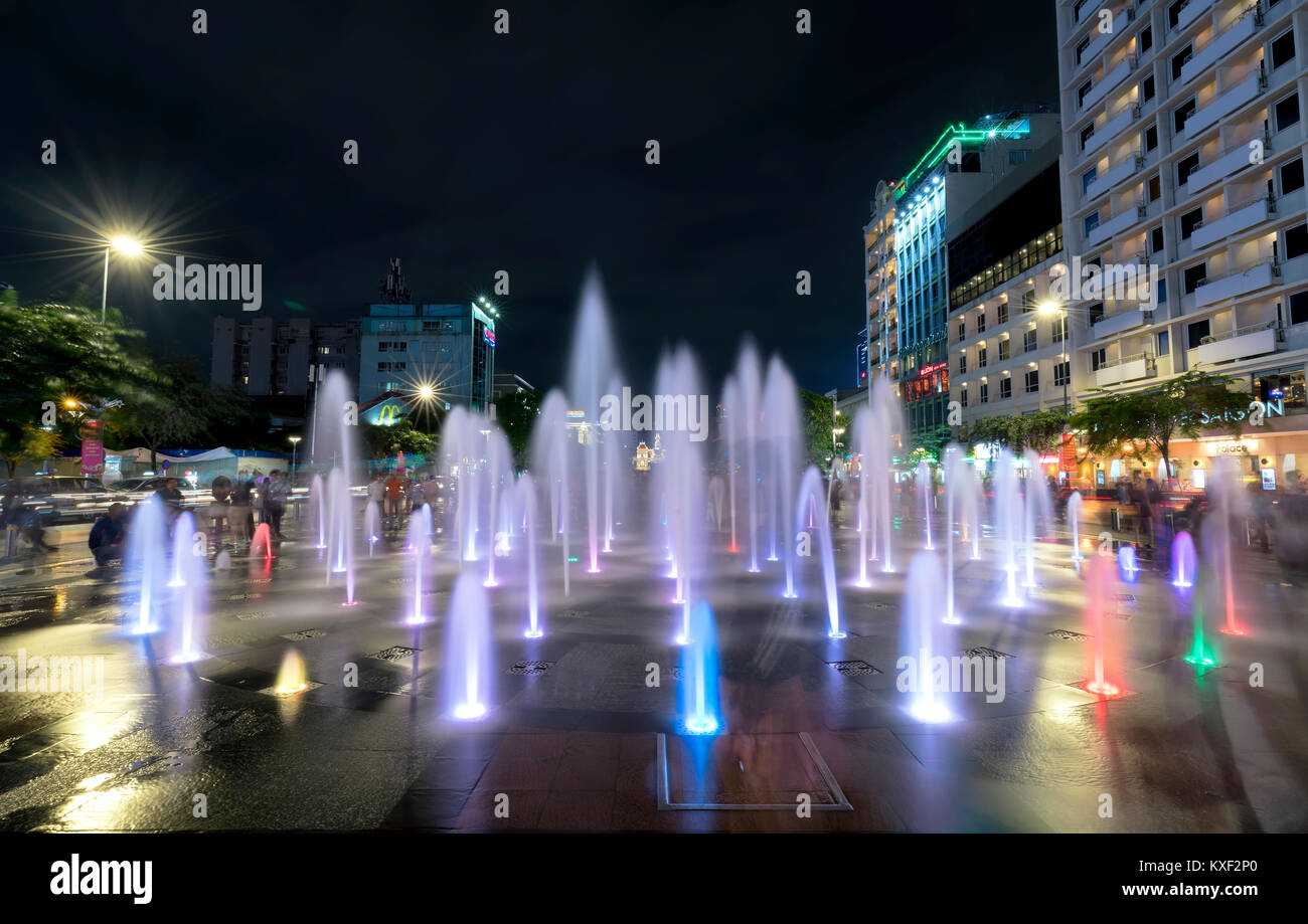 Light shimmering fountain at night on a pedestrian street and ...