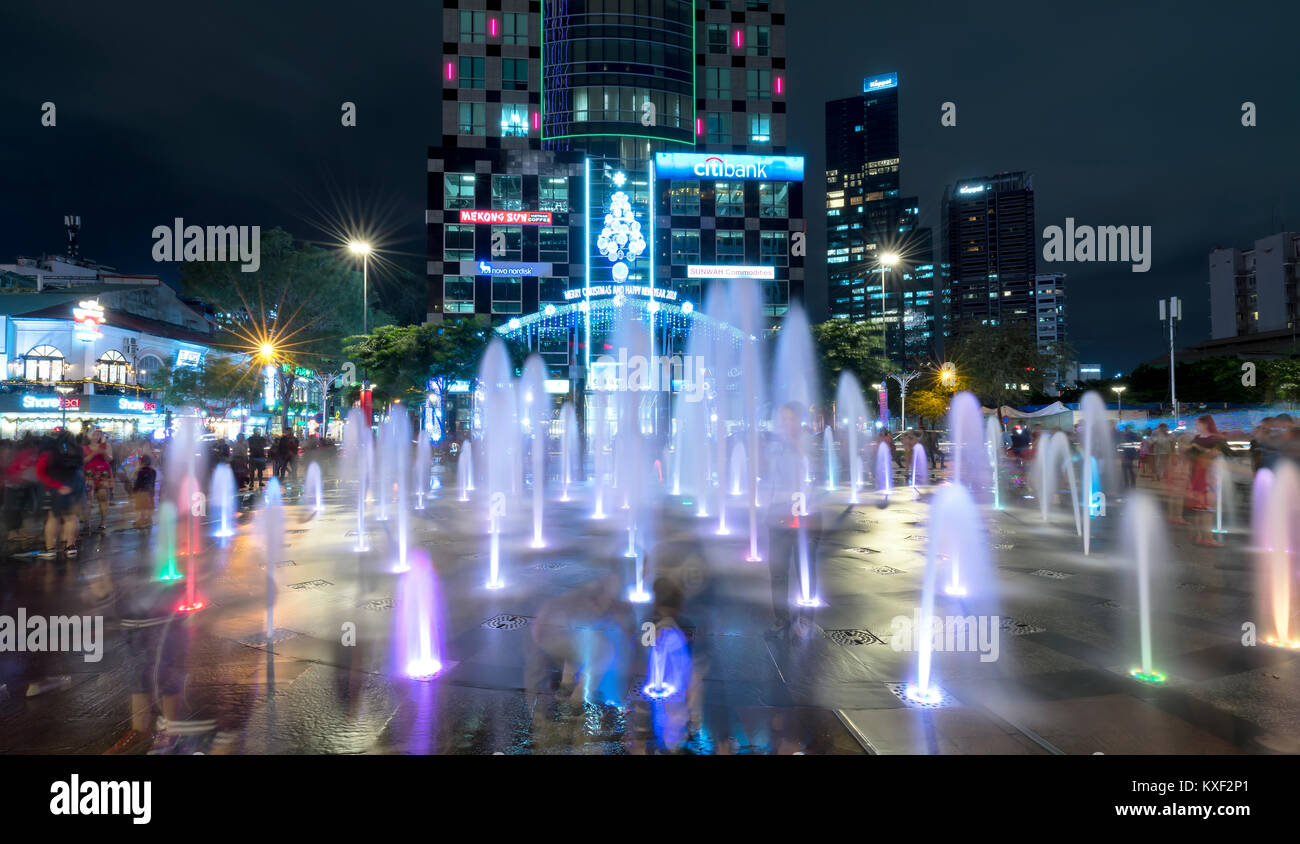 Light shimmering fountain at night on a pedestrian street and ...